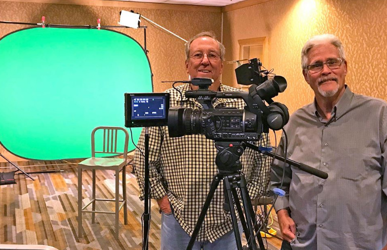 Video camera and green screen with two camera operators in San Diego hotel
